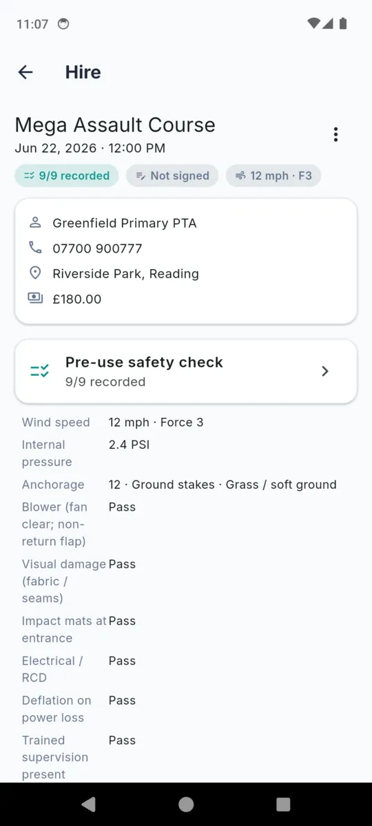 A hire in BounceLog showing the site, phone, address and fee, then the pre-use safety check summary with wind speed 12 mph Force 3, internal pressure 2.4 PSI, anchorage 12 ground stakes on grass, and each pass or fail item listed