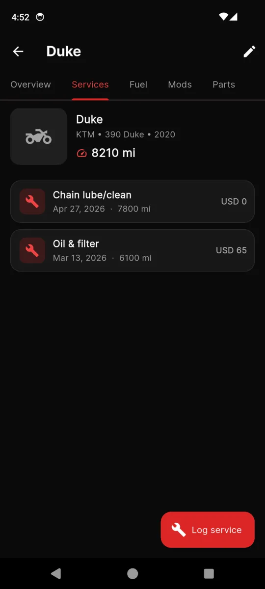 The services tab for a single bike in MotoGarage, listing each job with its date, odometer reading and cost