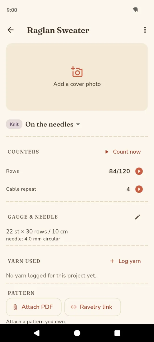 A StitchNest project screen showing a cover photo slot, an on-the-needles status, the counters rows and cable repeat, a gauge of 22 stitches by 30 rows per 10 cm on a 4 mm circular needle, a yarn used section and buttons to attach a pattern PDF or a Ravelry link