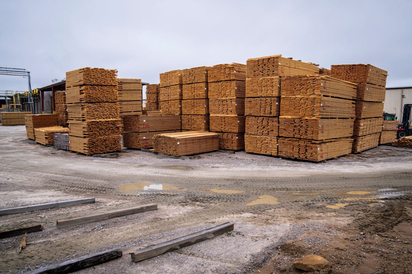 Stacks of sawn timber piled in an outdoor lumber yard