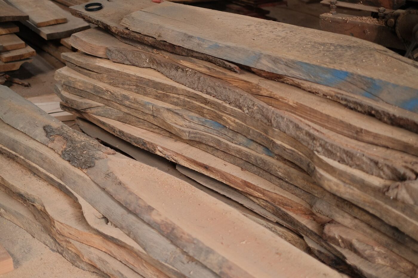 Rough sawn hardwood boards stacked in a workshop