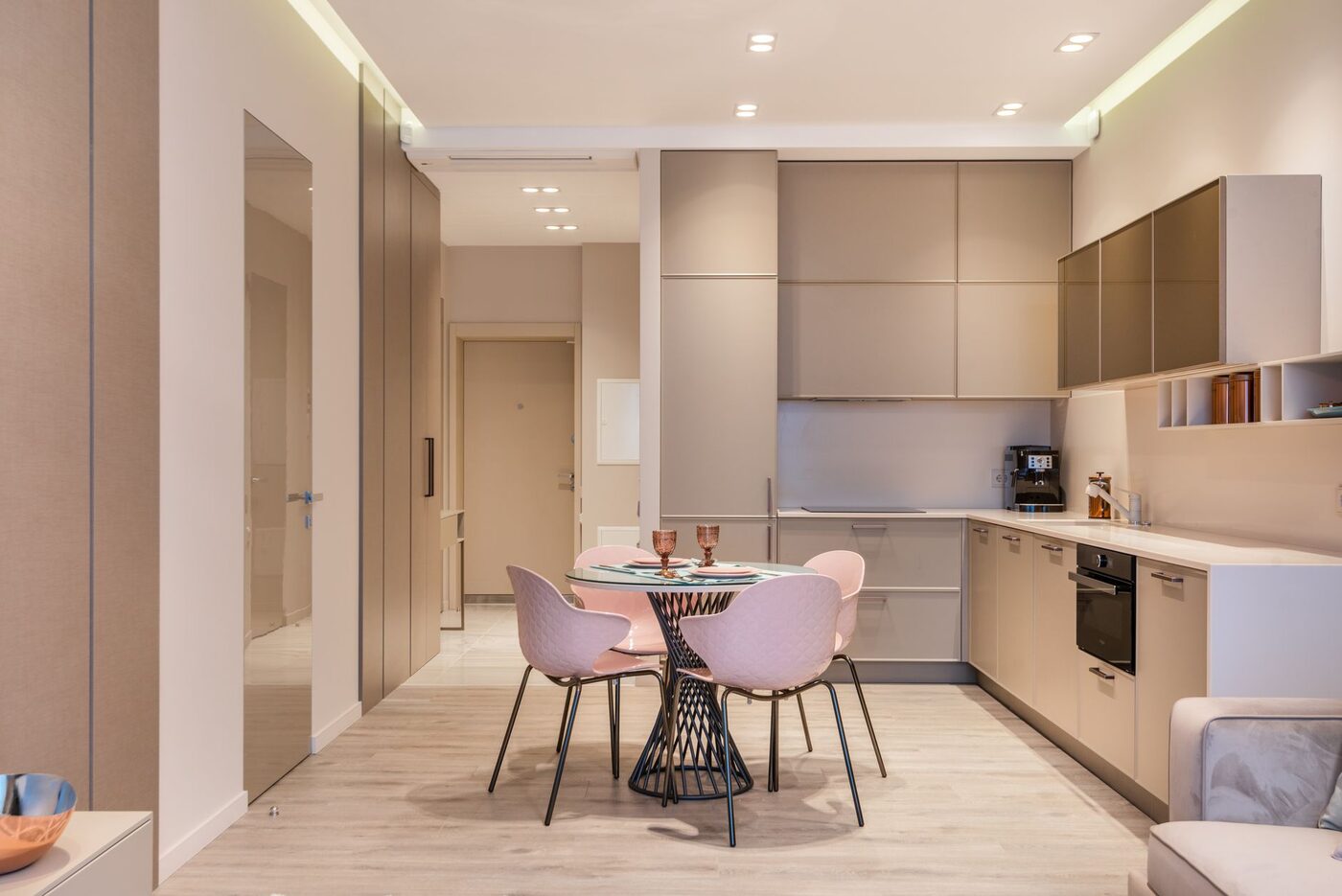 A furnished rental flat with fitted kitchen units, a built-in oven and a small round dining table