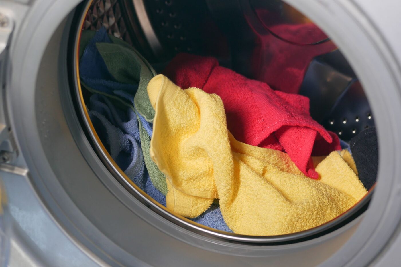 A washing machine drum loaded with towels