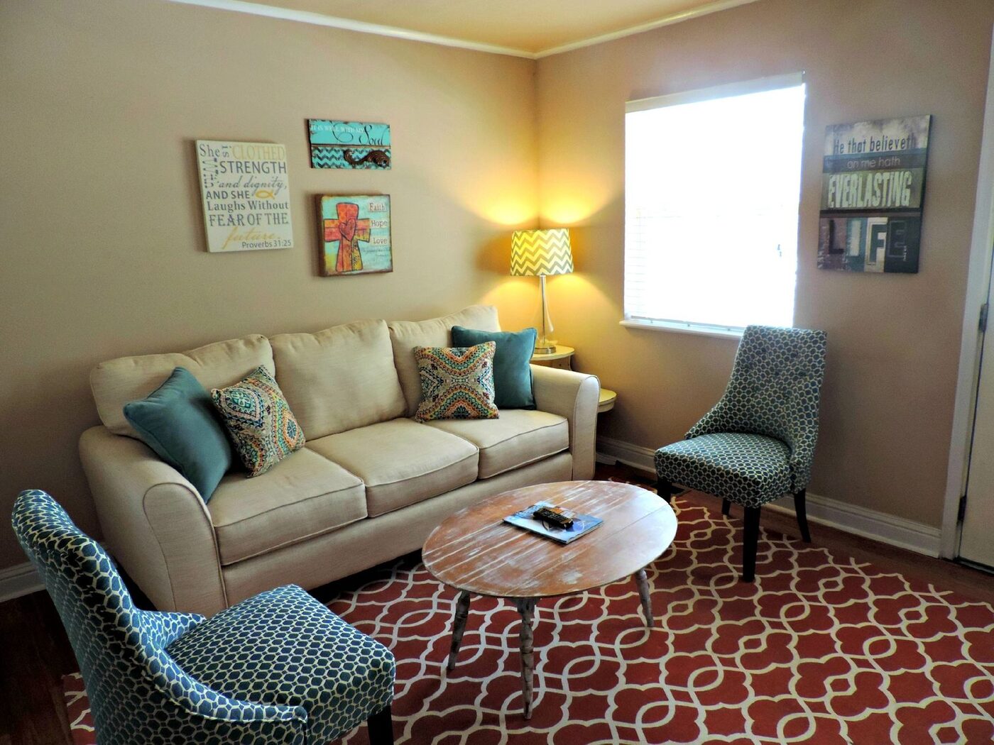 A furnished living room with sofa, armchairs and a coffee table