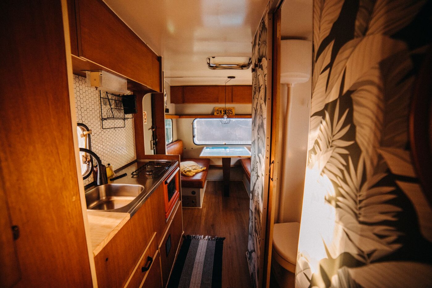 Interior of a camper showing the kitchenette sink and taps