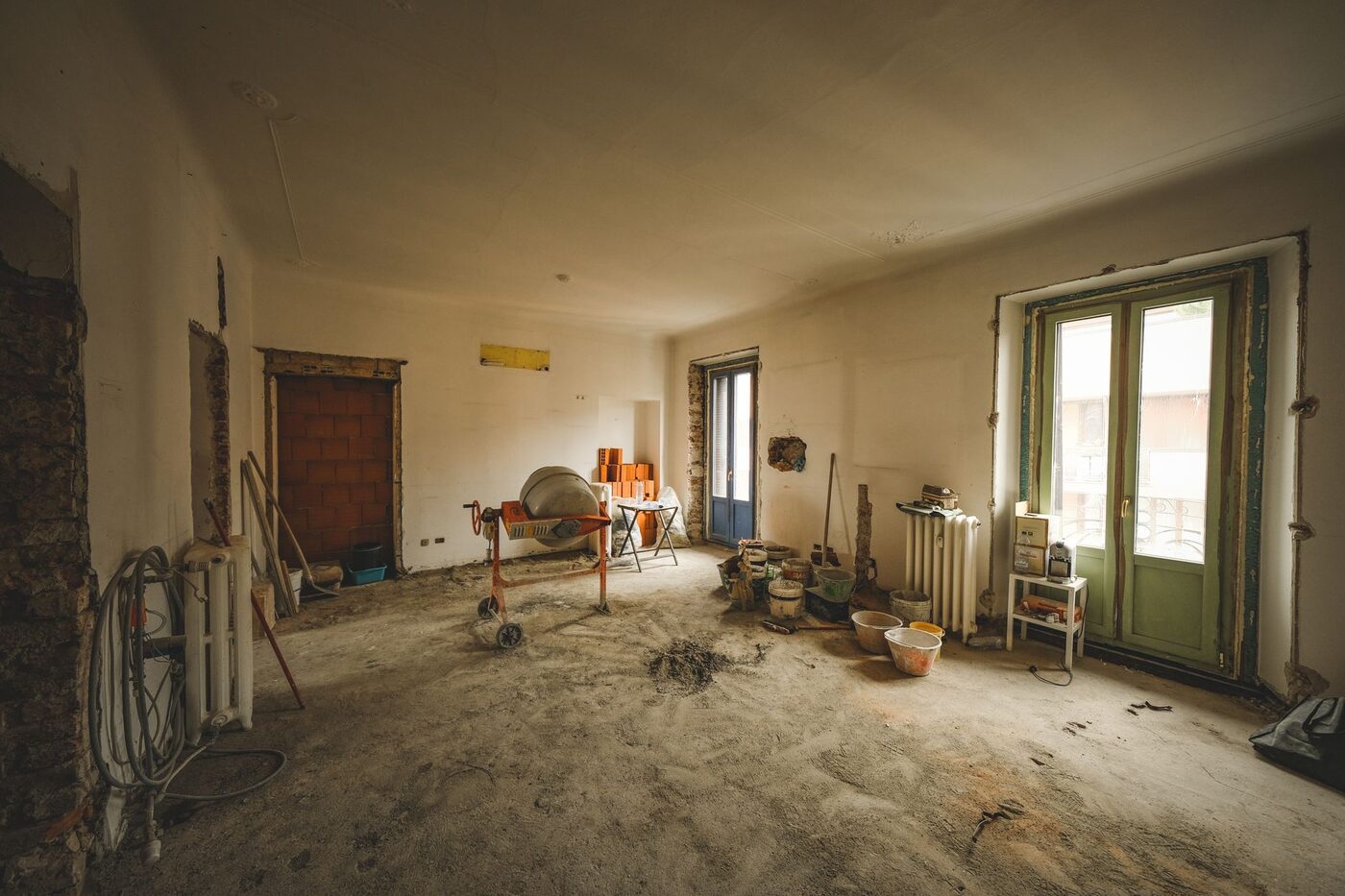 A room stripped back mid-renovation with tools and materials on the bare floor
