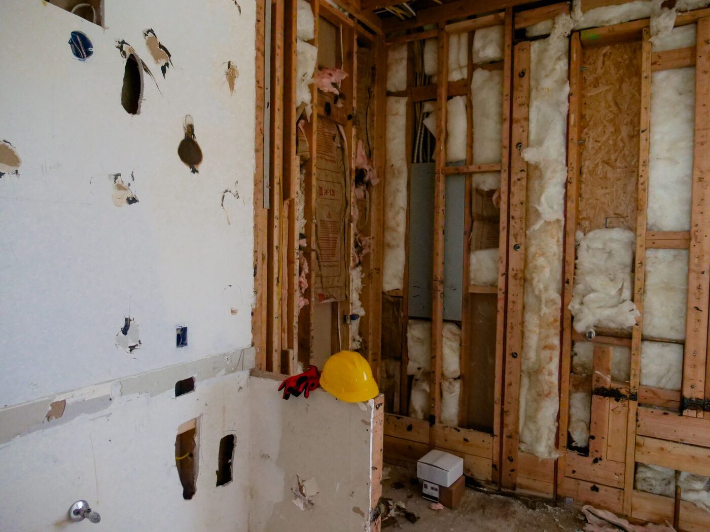 A stripped-back interior with open stud walls and services exposed before boarding