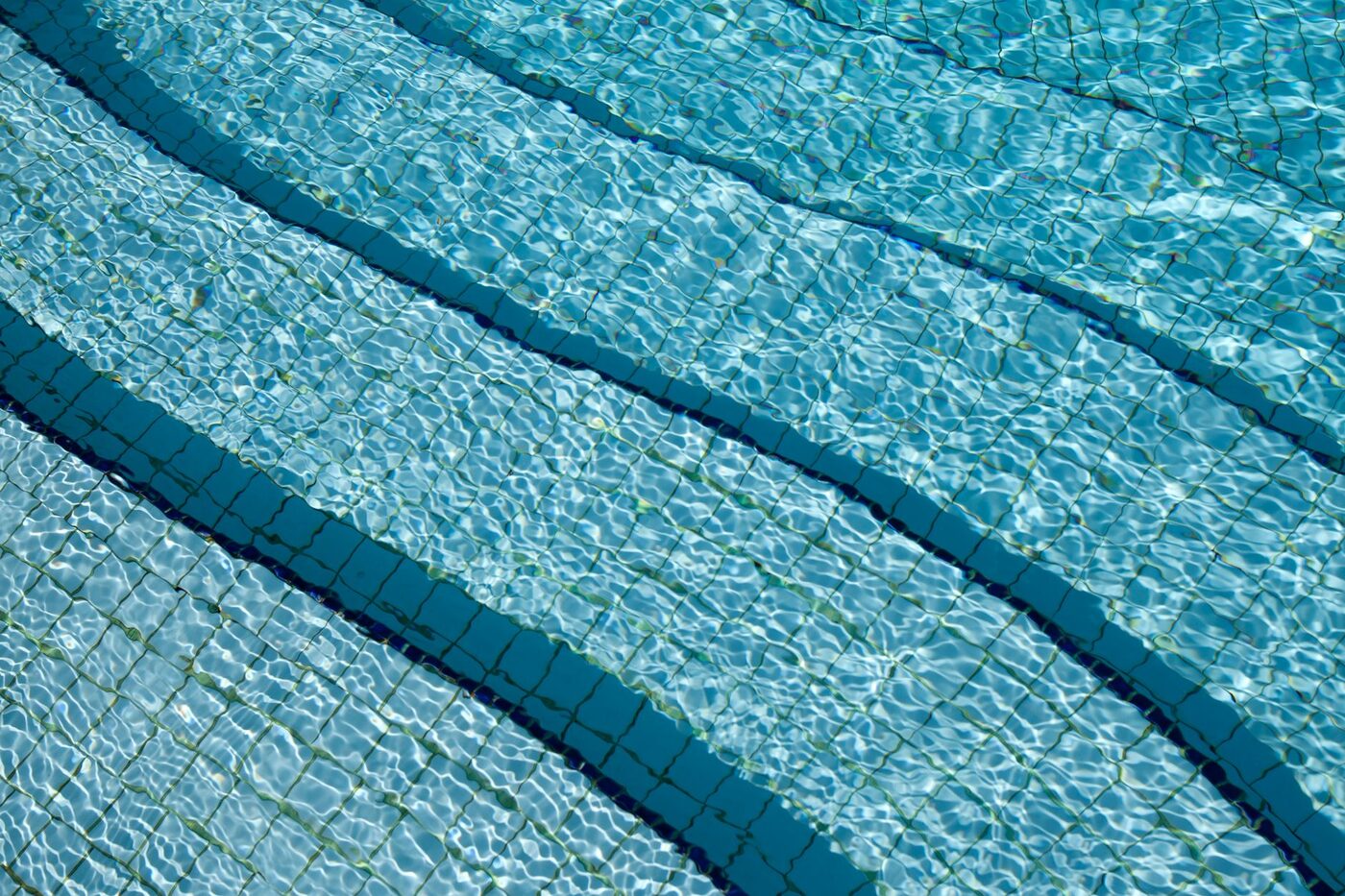 Clear pool water over blue tiles