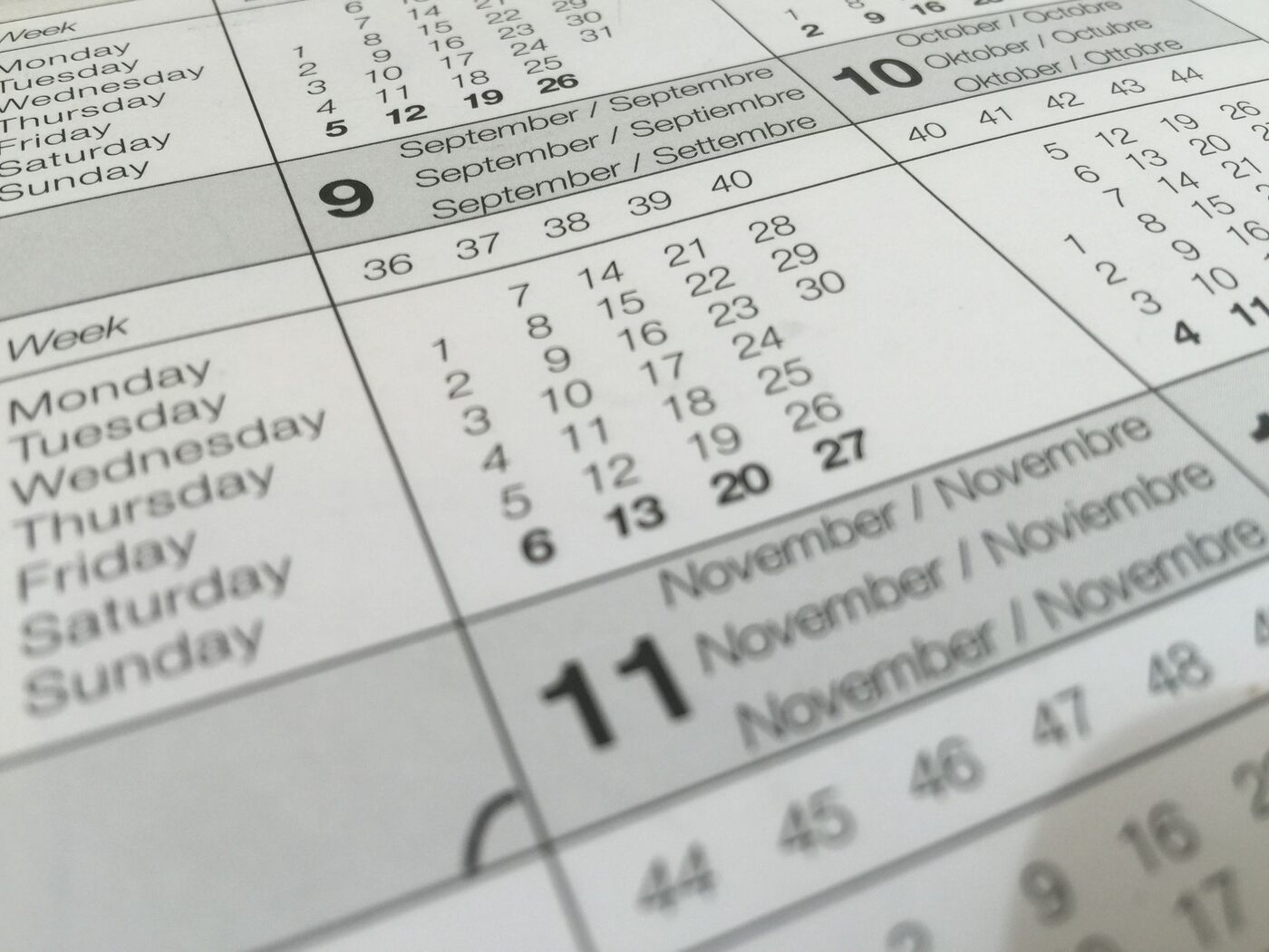 Close-up of a printed wall calendar showing weeks and month names
