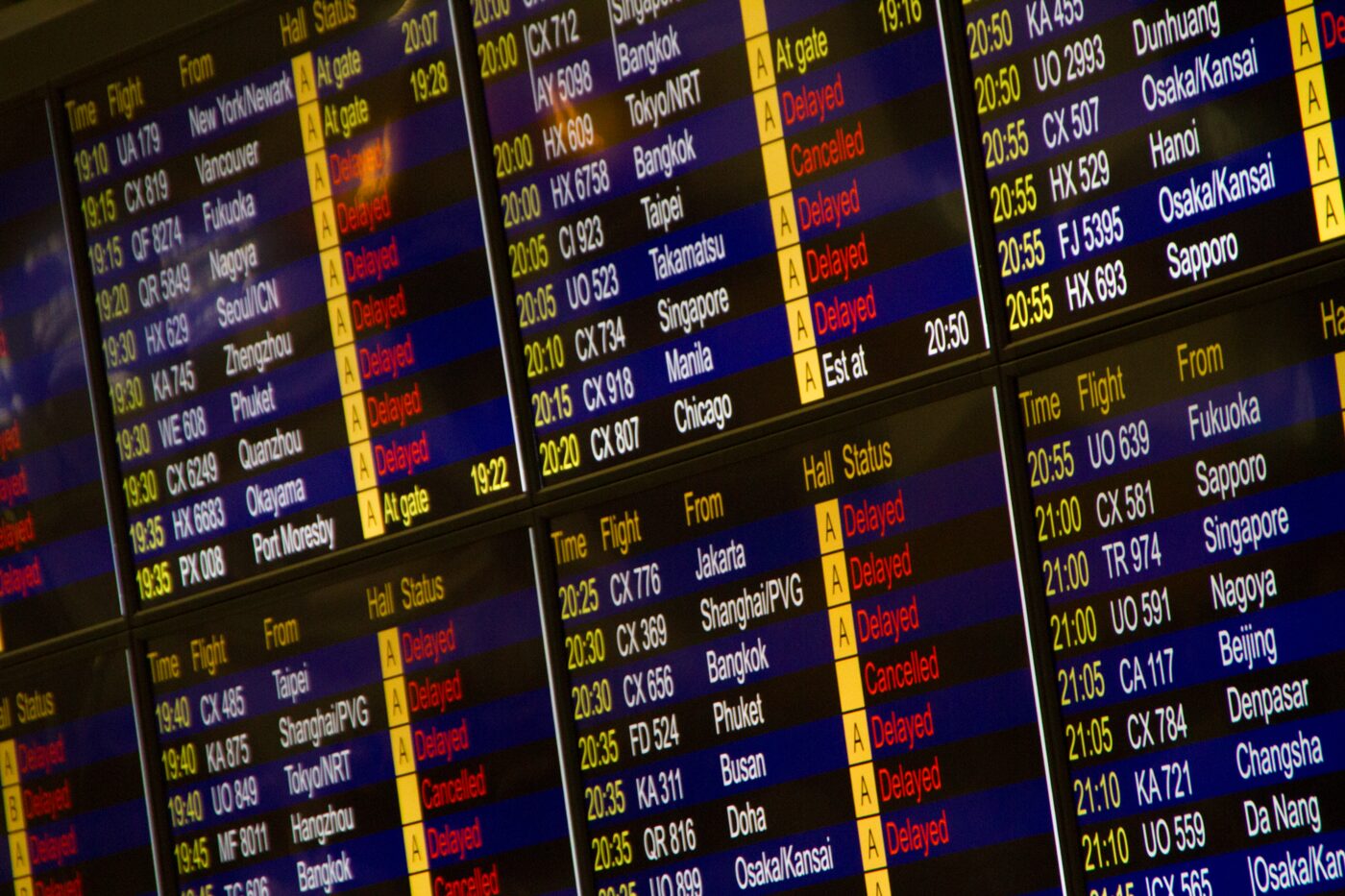 Airport departure board showing flight times and destinations