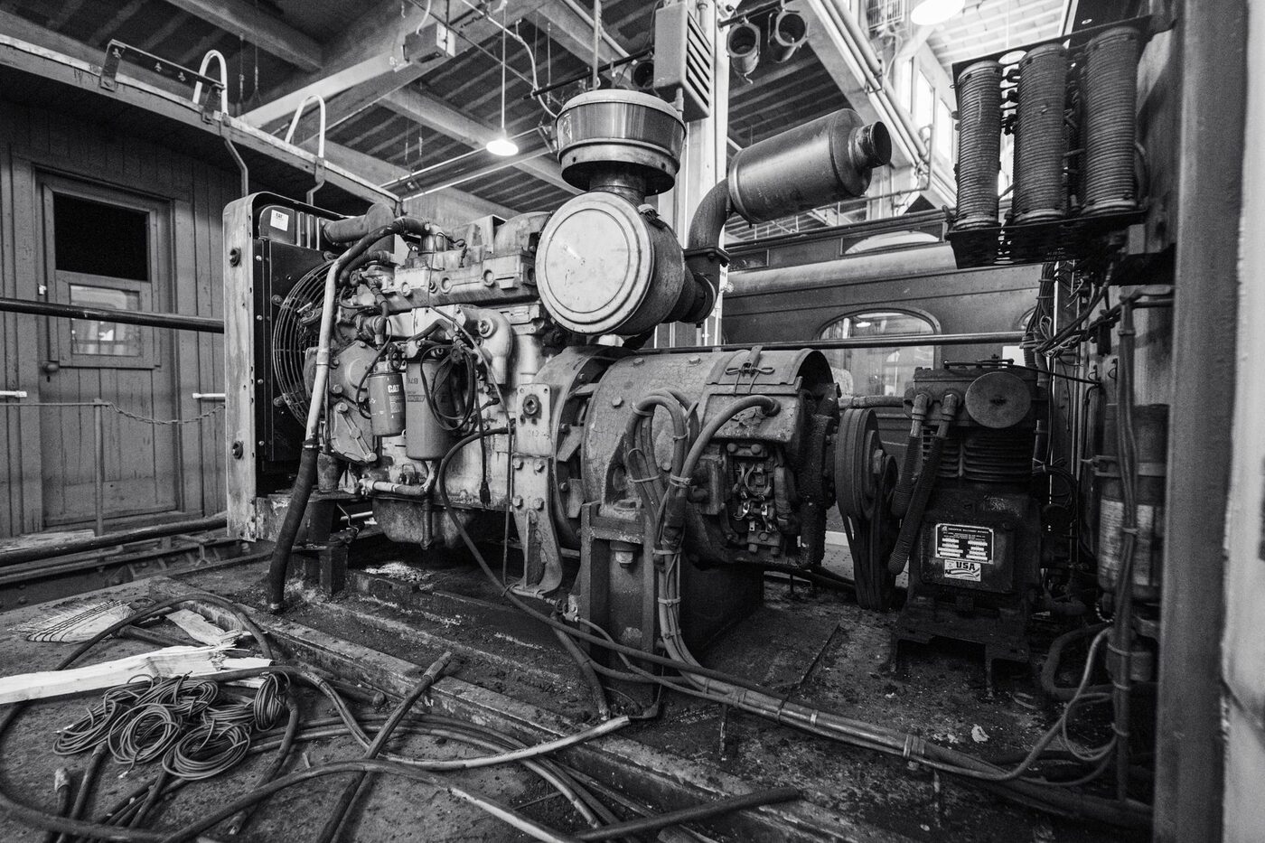 A large stationary engine and generator set in a plant room
