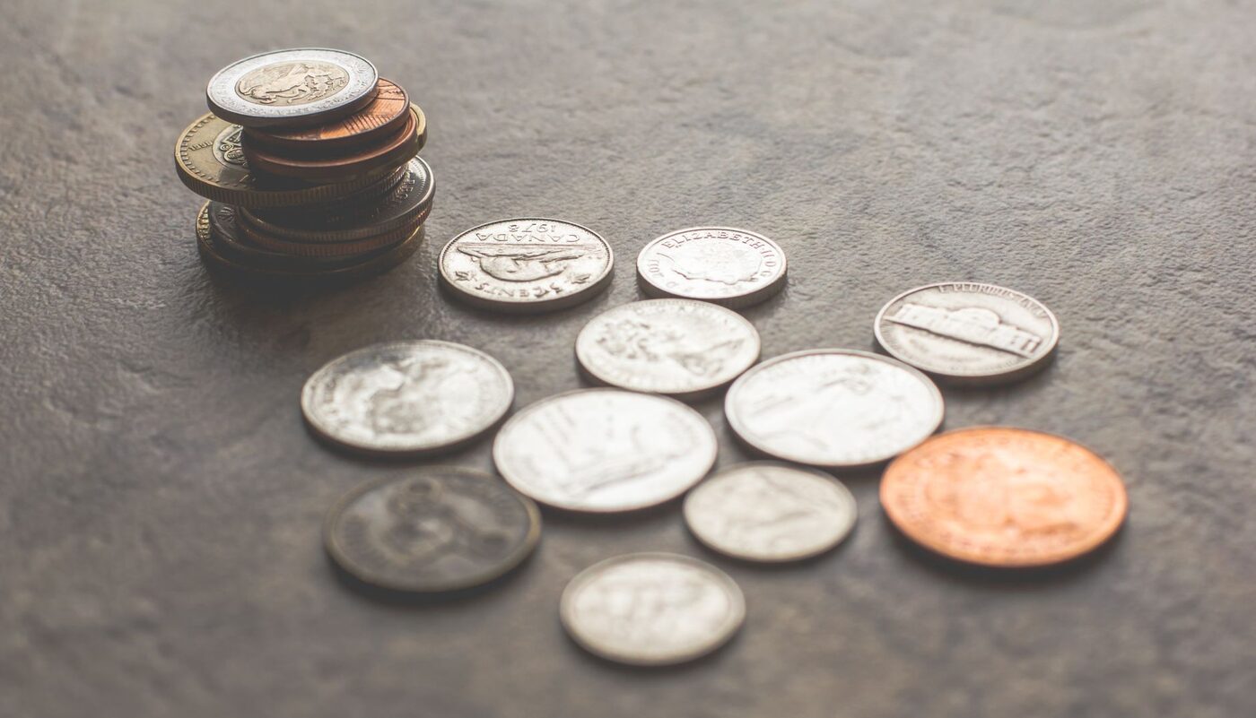 Assorted coins on a grey surface