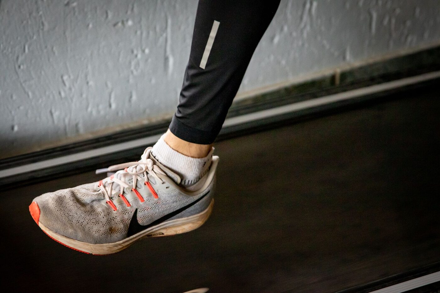 A runner mid-stride in running shoes